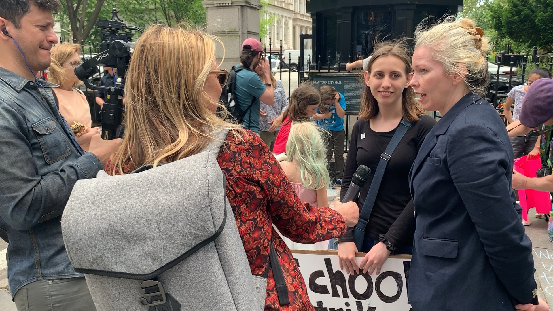 Julie Pullen outside speaking with youth activists during filming