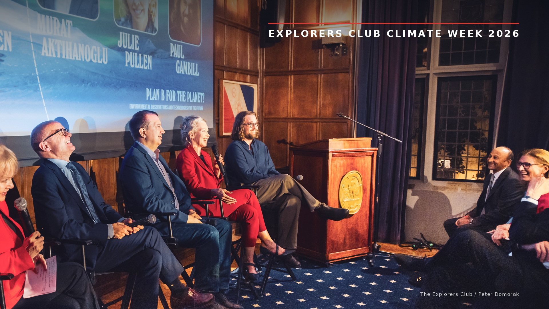 Dr. Julie Pullen speaking on an Explorers Club Climate Week 2026 panel, with other panelists seated on stage and an audience listening.